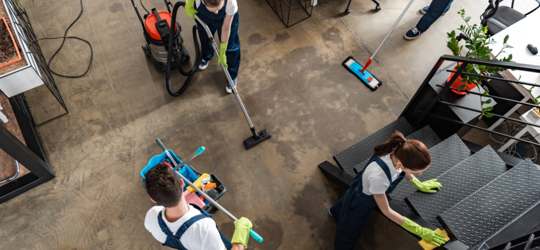 Top view of cleaners working hard in a modern office building.