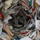 A swirling vortex of colorful books and papers. Text on some book spines is visible.