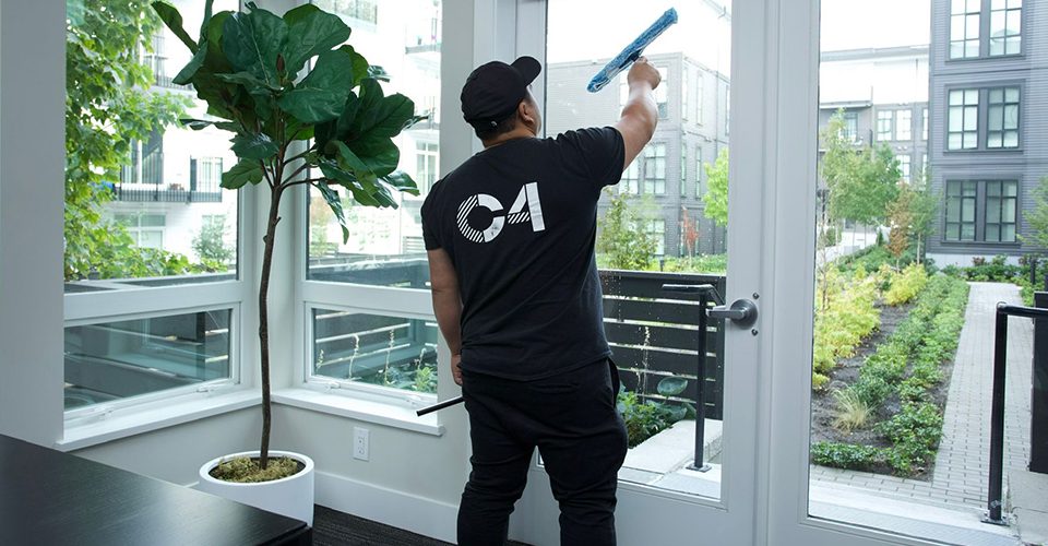 Professional cleaning maintenance personnel sanitizing an office.