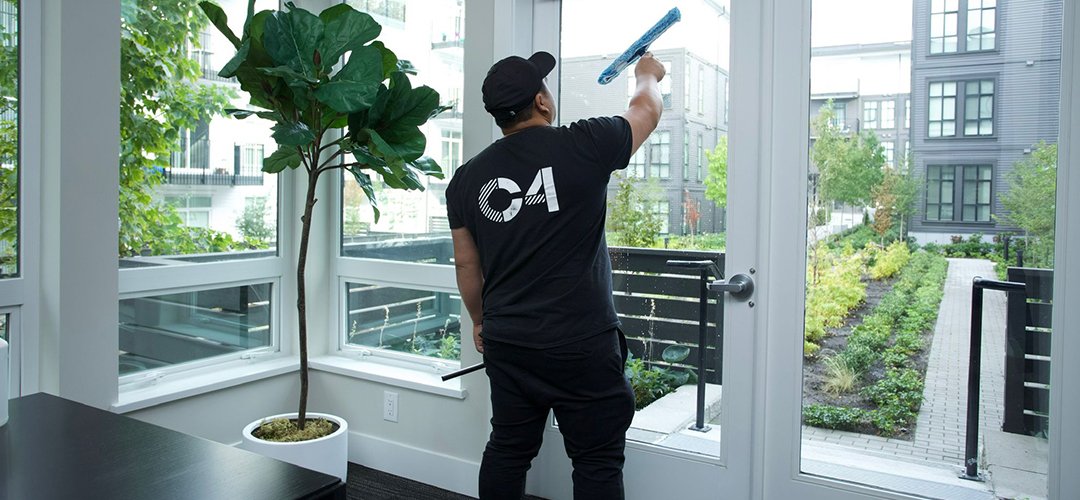 Professional cleaning maintenance personnel sanitizing an office.