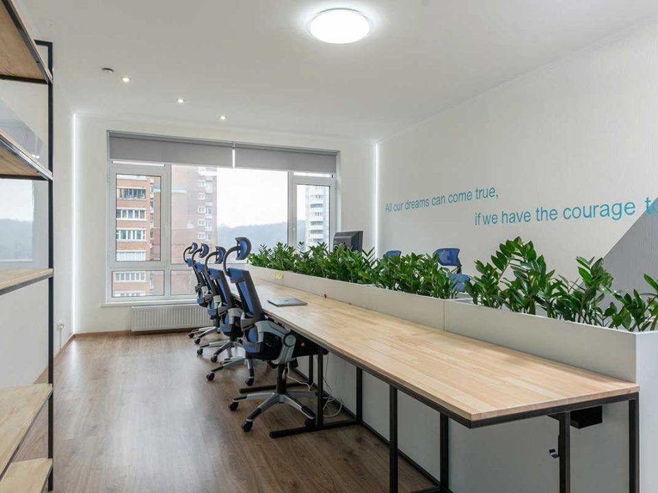 A sleek and modern office space designed for productivity and collaboration, featuring ergonomic chairs and plenty of natural light.