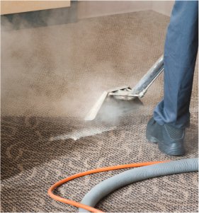 A professional cleaning technician uses a steam cleaner on a commercial carpet, effectively removing dirt, stains, and odors for a pristine finish.