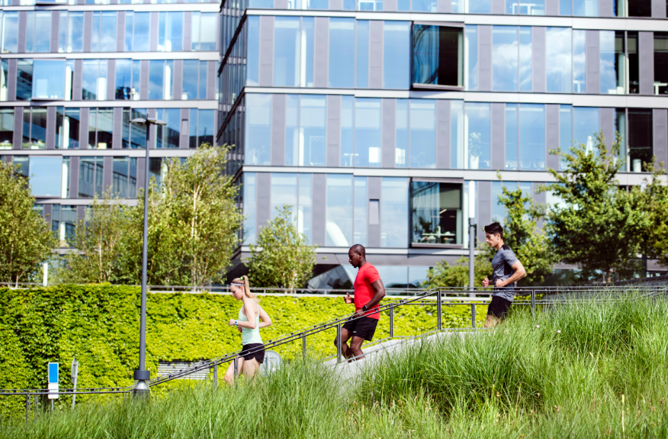 A group of people running through an urban environment.